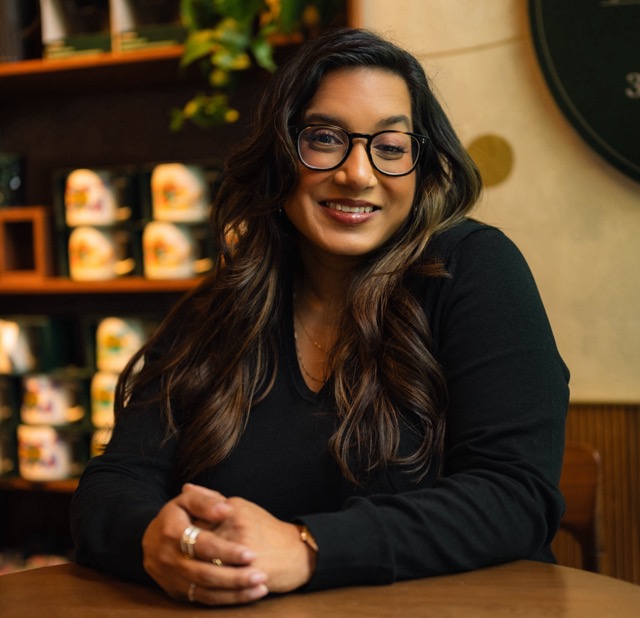 Rashni Patel A woman sitting at a table smiling