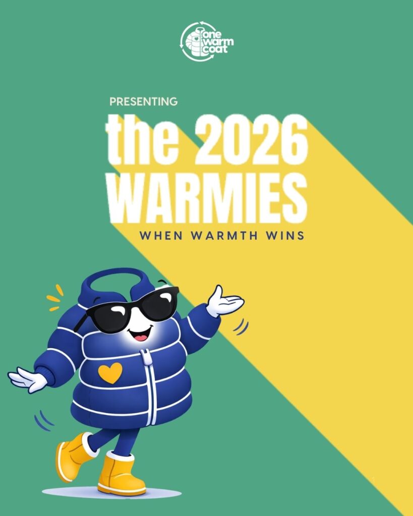 The image features a cartoon coat character wearing sunglasses with the text "Presenting the 2026 Warmies: When Warmth Wins."